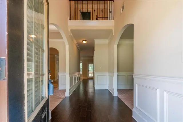 a view of a hallway with wooden floor and glass door