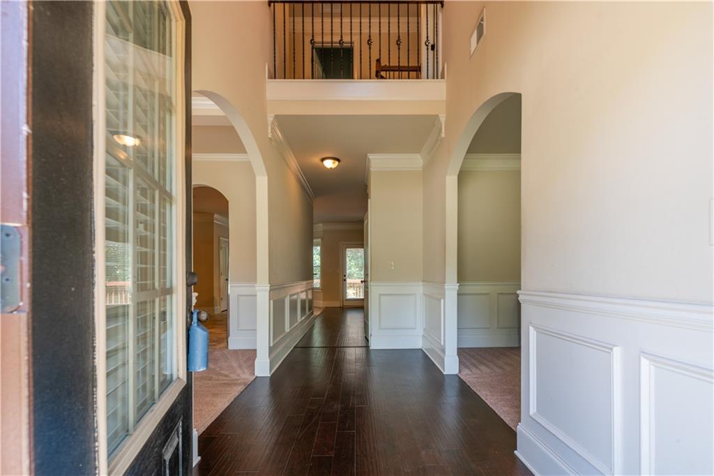 1412 Turnbridge Walk Hampton, GA 30228 - Photo 5 of 40 a view of a hallway with wooden floor and glass door