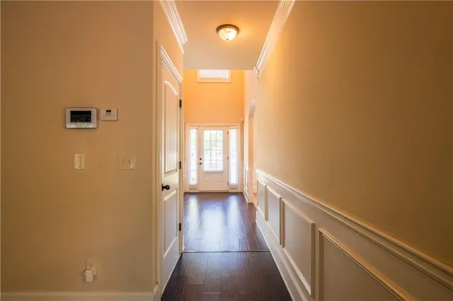 a view of a hallway with wooden floor and staircase