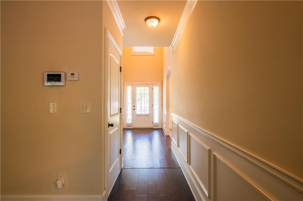 1412 Turnbridge Walk Hampton, GA 30228 - Photo 9 of 40 a view of a hallway with wooden floor and staircase