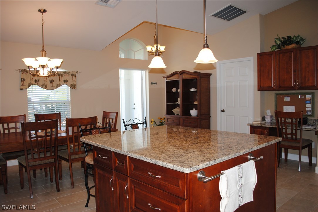 5891 Tarpon Road Bokeelia, FL 33922 - Photo 11 of 25 a kitchen with a table and chairs in it