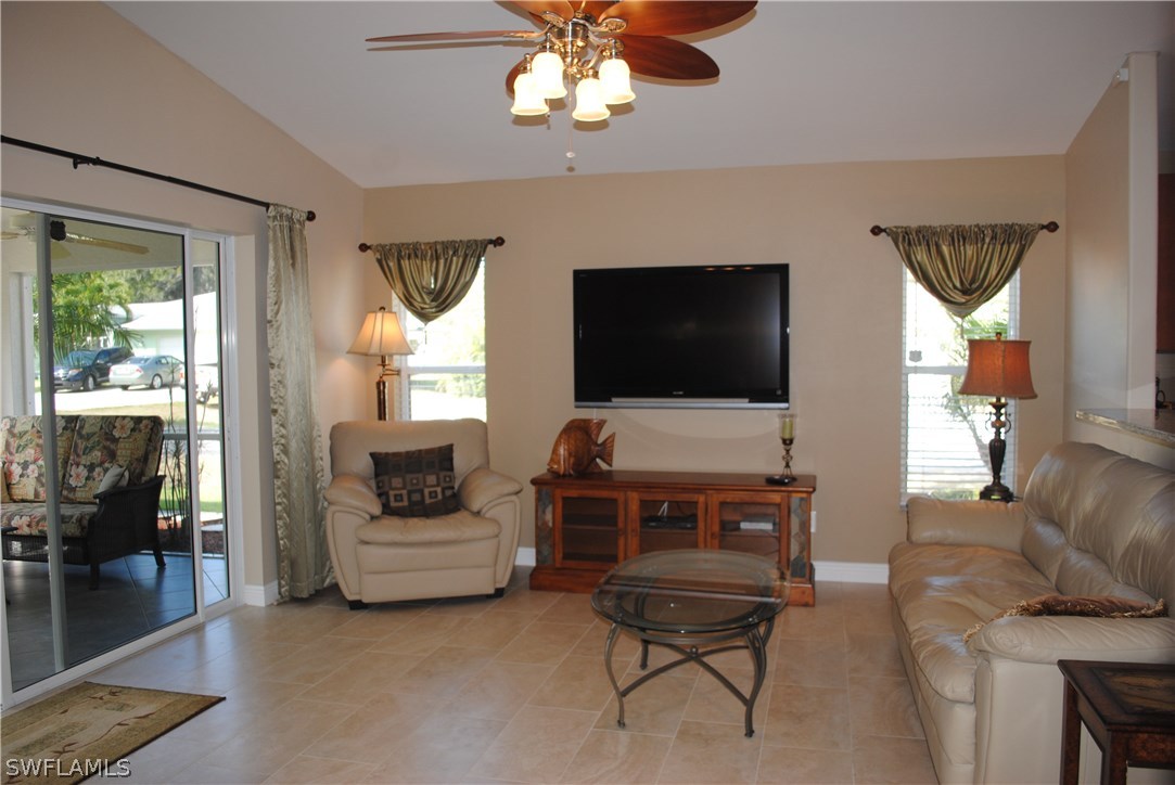 5891 Tarpon Road Bokeelia, FL 33922 - Photo 15 of 25 a living room with furniture a flat screen tv and a large window