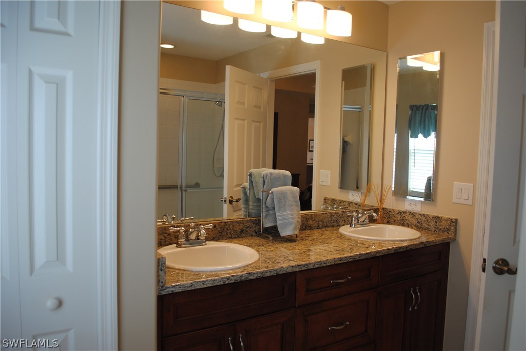 5891 Tarpon Road Bokeelia, FL 33922 - Photo 18 of 25 a bathroom with a granite countertop sink and a mirror