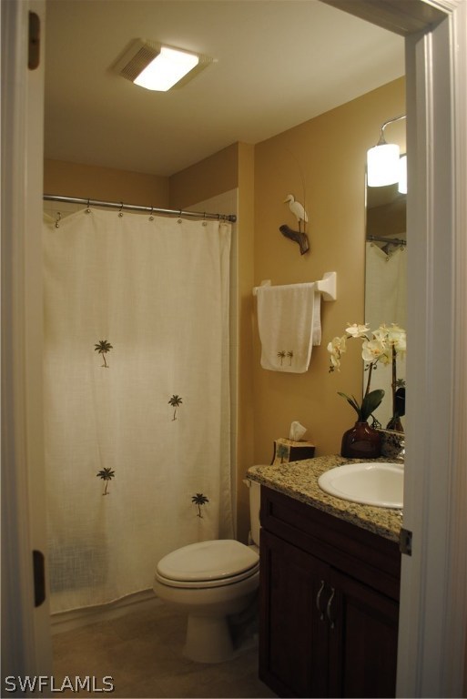 5891 Tarpon Road Bokeelia, FL 33922 - Photo 20 of 25 a bathroom with a sink and mirror with toilet