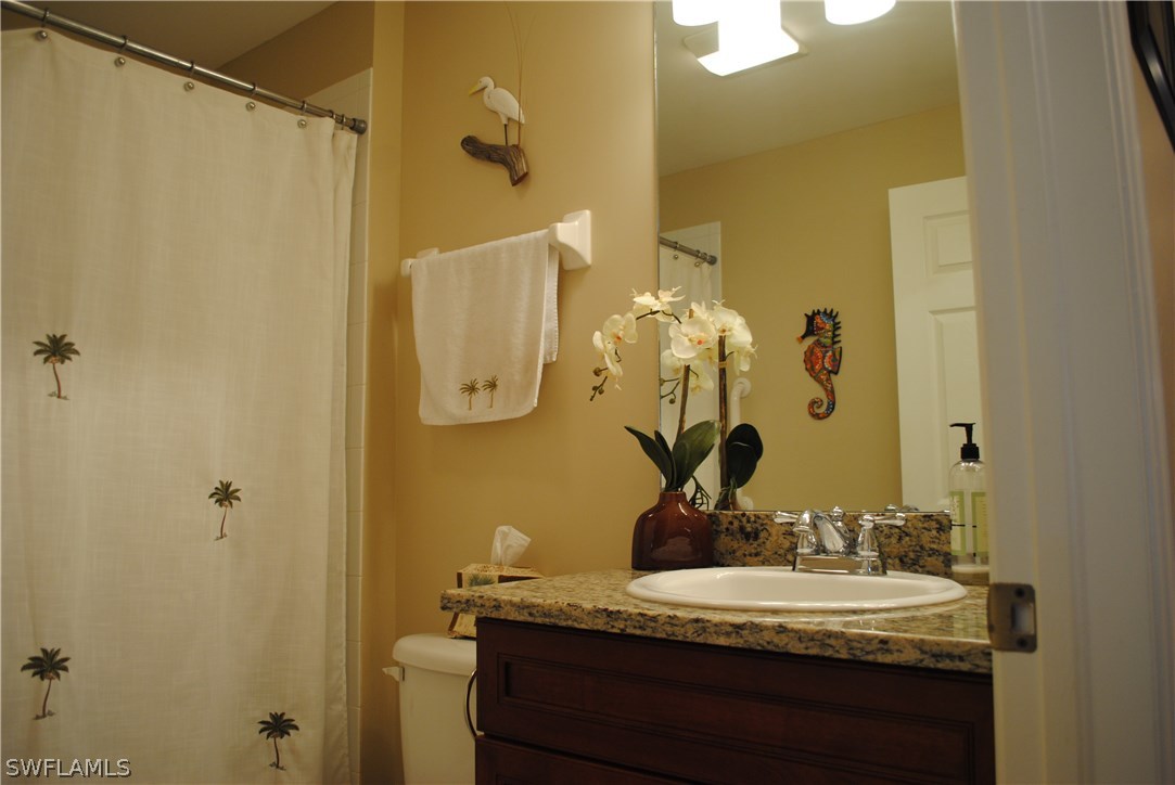 5891 Tarpon Road Bokeelia, FL 33922 - Photo 21 of 25 a bathroom with a granite countertop sink and a mirror