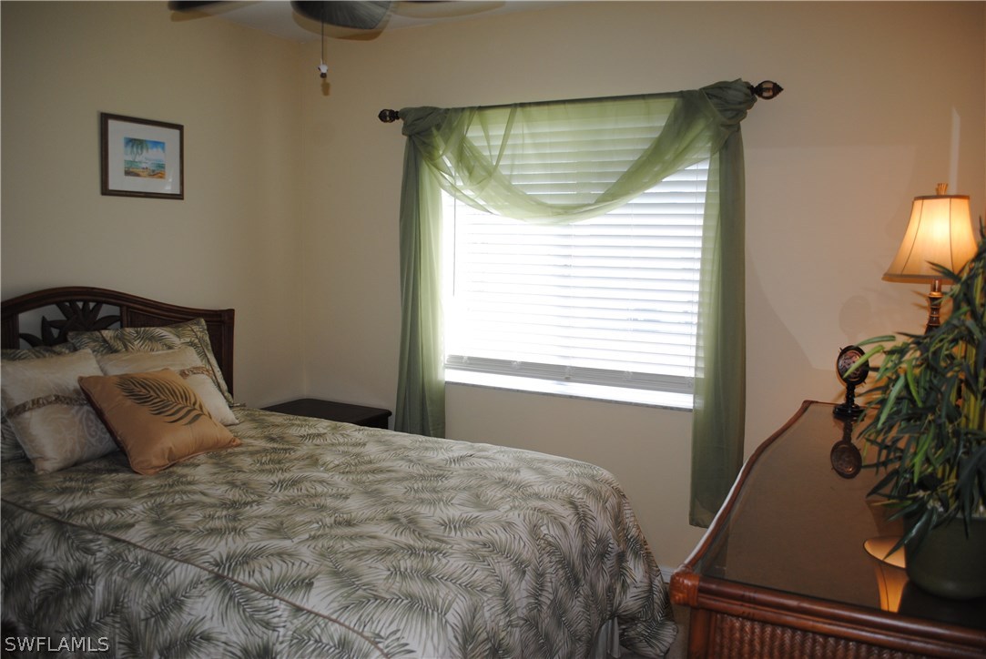 5891 Tarpon Road Bokeelia, FL 33922 - Photo 23 of 25 a bedroom with a bed and a window