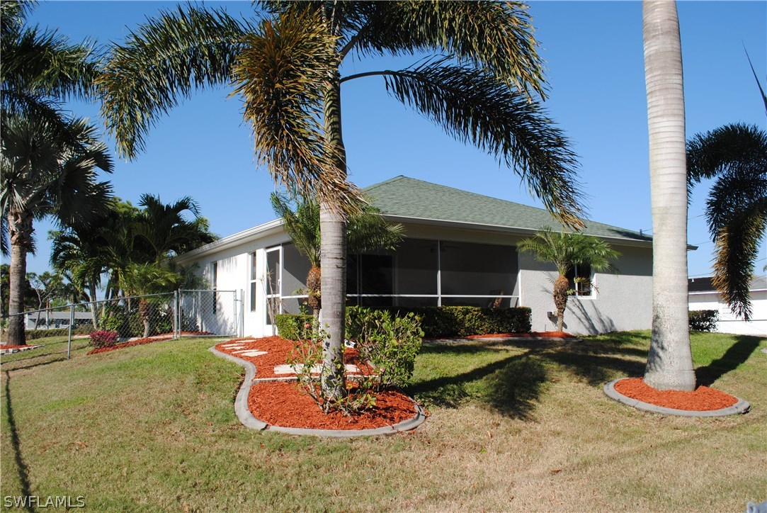 5891 Tarpon Road Bokeelia, FL 33922 - Photo 3 of 25 a backyard of a house with fountain table and chairs
