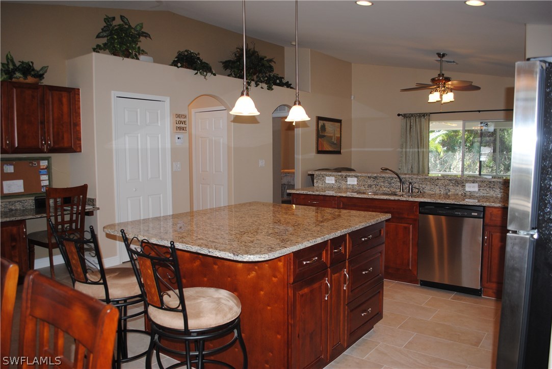 5891 Tarpon Road Bokeelia, FL 33922 - Photo 10 of 25 a kitchen with a dining table and chairs