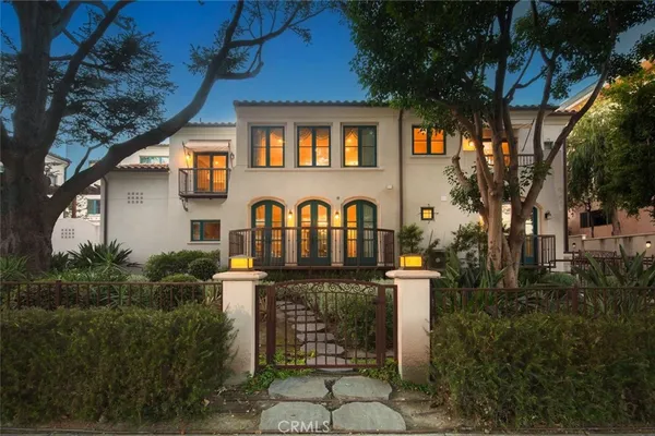 a front view of a house with plants