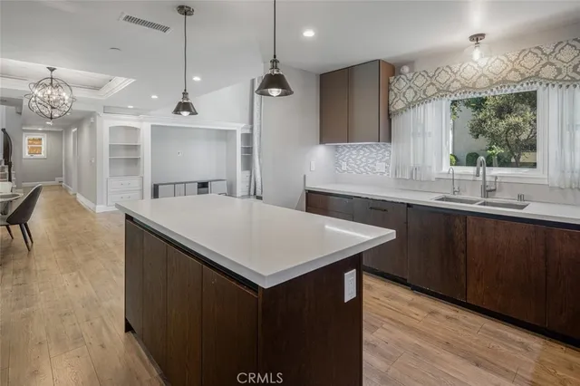 a kitchen with granite countertop a stove and a sink
