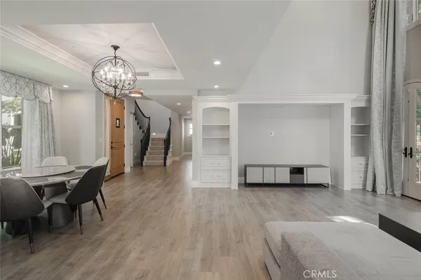 a view of staircase with wooden floor and white walls