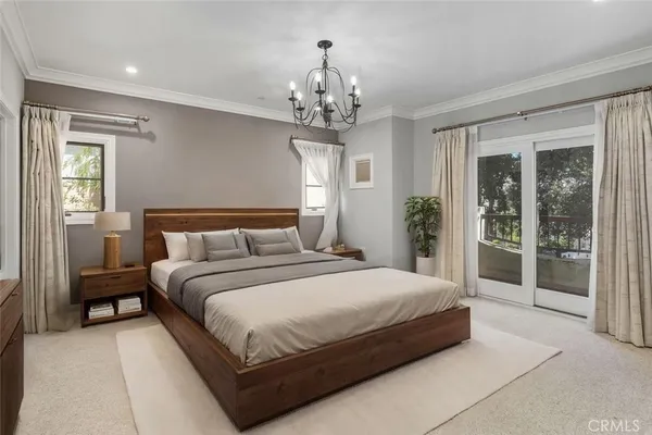 a bedroom with a bed and a potted plant