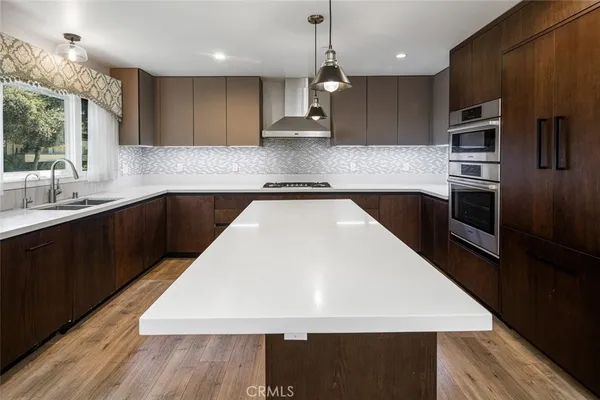 a kitchen with stainless steel appliances a stove and a refrigerator