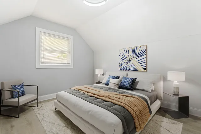 a bedroom with a bed and a lamp