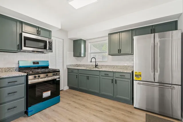a kitchen with a refrigerator stove and sink