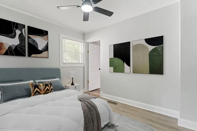 a bedroom with a bed and a large mirror