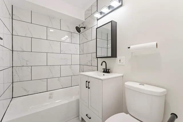 a bathroom with a toilet a sink and bathtub