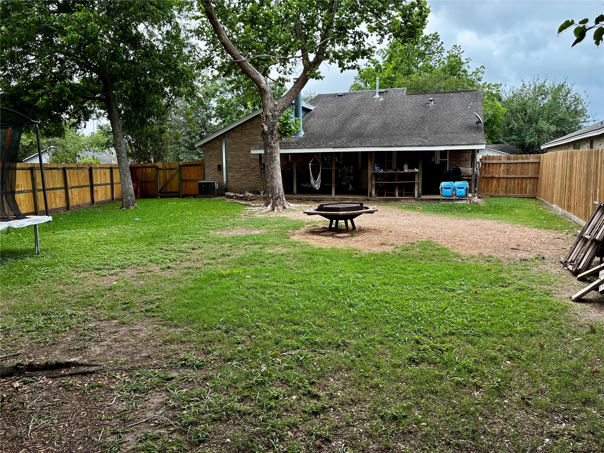 2 Sarita Road Angleton, TX 77515 - Photo 18 of 21 a view of backyard with table and chairs and wooden fence