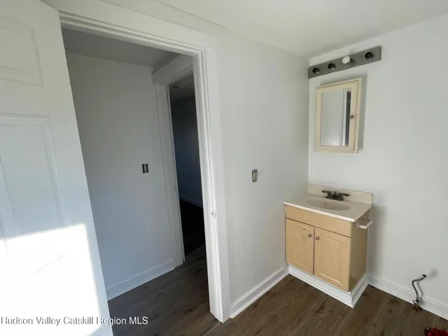 a room with a sink and a mirror