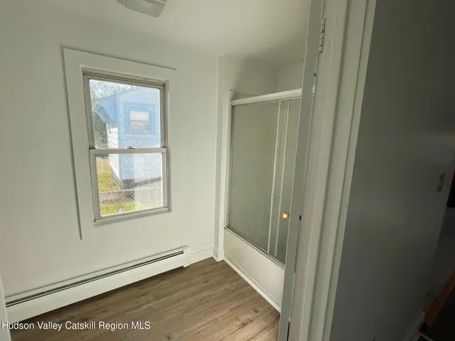 an empty room with windows and closet