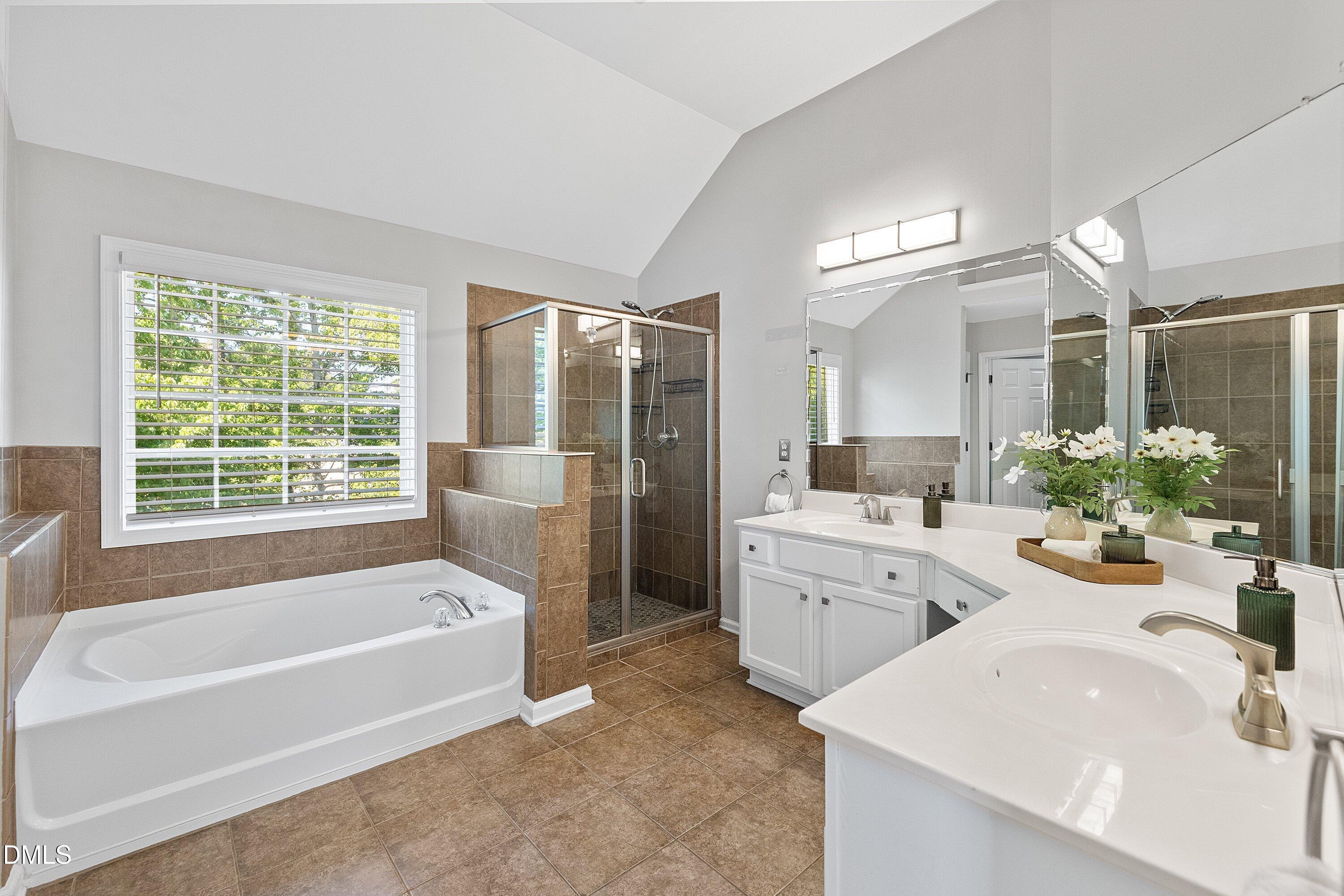 3717 Windmeade Road Wake Forest, NC 27587 - Photo 31 of 51 a spacious bathroom with sink shower bathtub and mirror