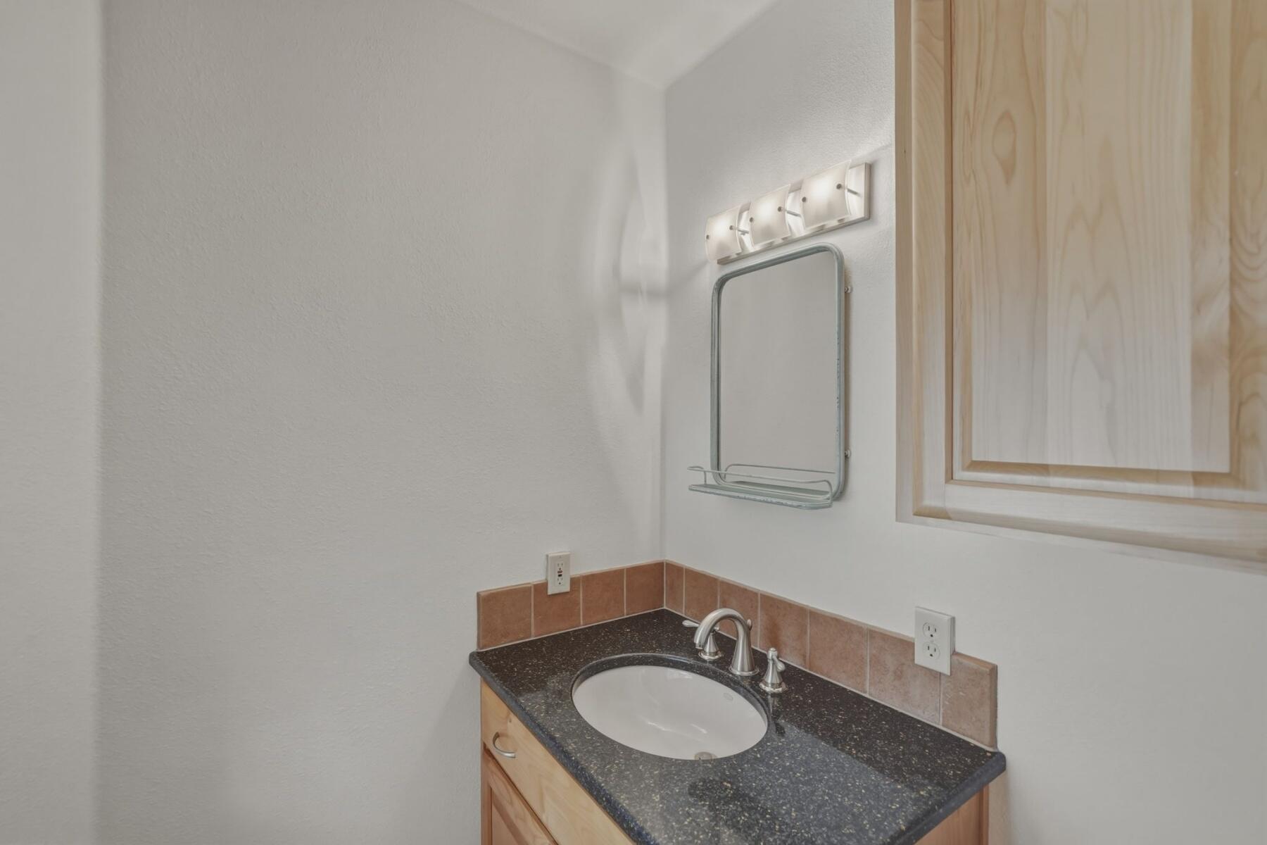 637 Northwest Silver Buckle Road Bend, OR 97703 - Photo 17 of 68 a bathroom with a sink and a mirror