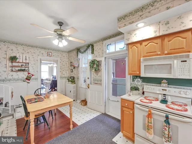a living room with stainless steel appliances kitchen island granite countertop furniture and a kitchen view