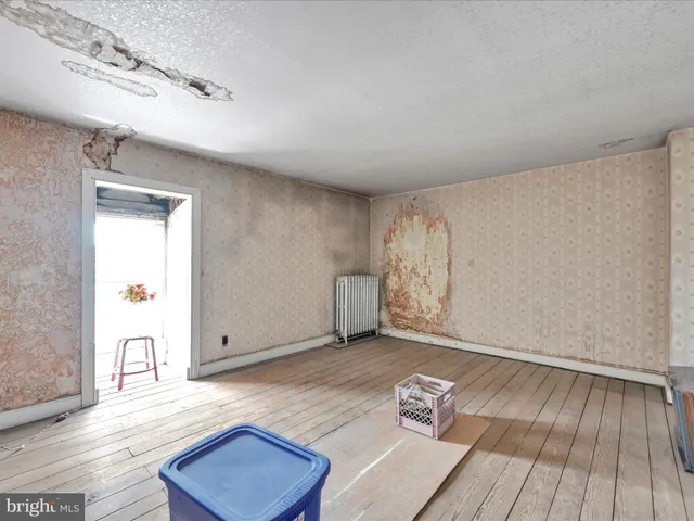 a view of room with hardwood floor and window