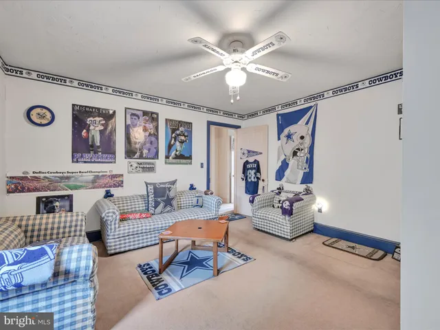 a living room with furniture and paintings on the wall