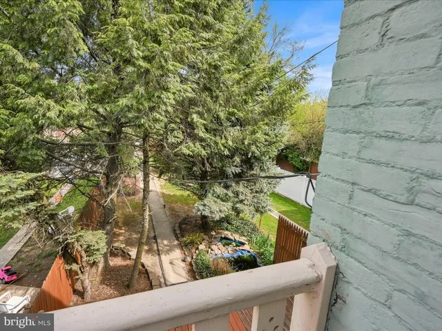 a white house that has a tree in front of it