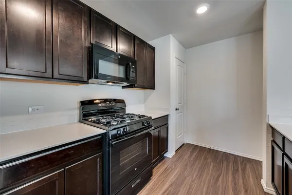 a kitchen with granite countertop wooden cabinets and stainless steel appliances