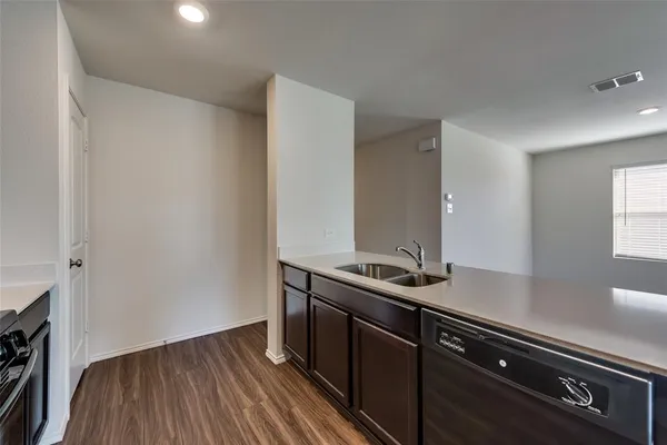 a room with a sink and wooden floor