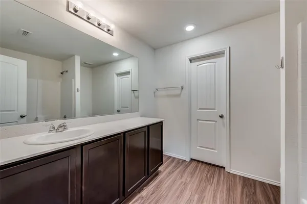 a bathroom with a double vanity sink and mirror