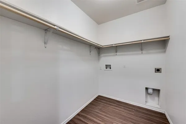 a view of a room with wooden floor