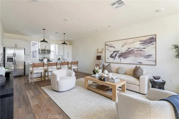 a living room with furniture and wooden floor