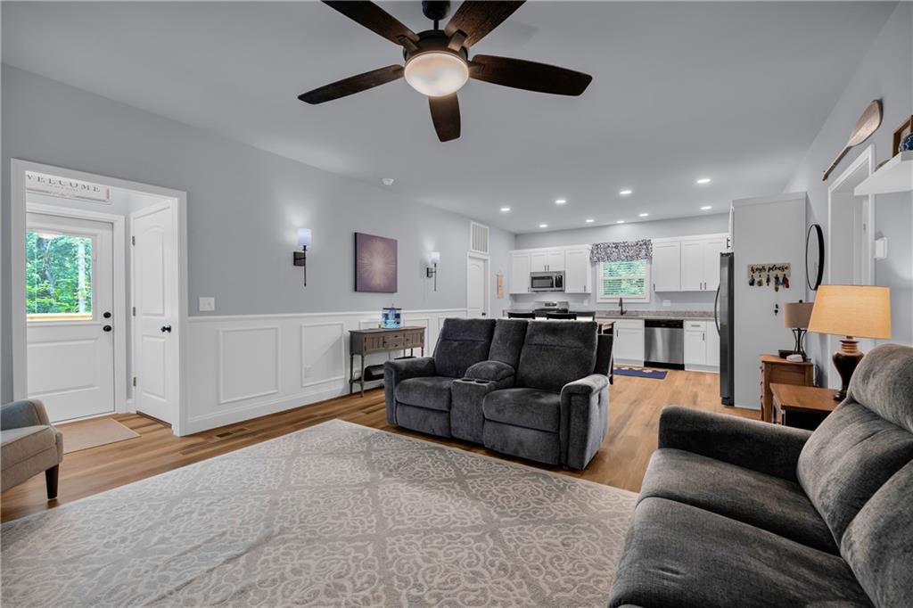 397 Normandy Trail Lavonia, GA 30553 - Photo 12 of 47 a living room with furniture kitchen view and a chandelier