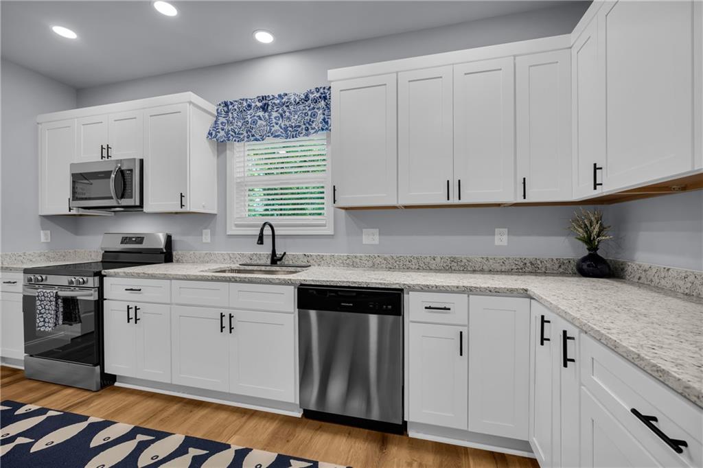 397 Normandy Trail Lavonia, GA 30553 - Photo 18 of 47 a kitchen with appliances cabinets and a sink