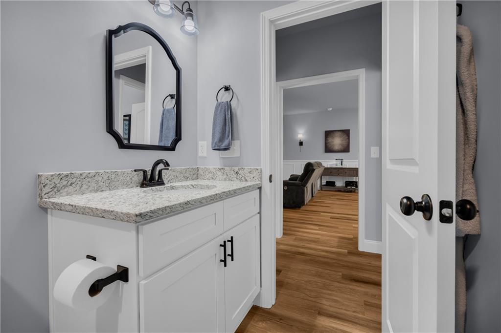 397 Normandy Trail Lavonia, GA 30553 - Photo 25 of 47 a bathroom with a granite countertop sink and a mirror