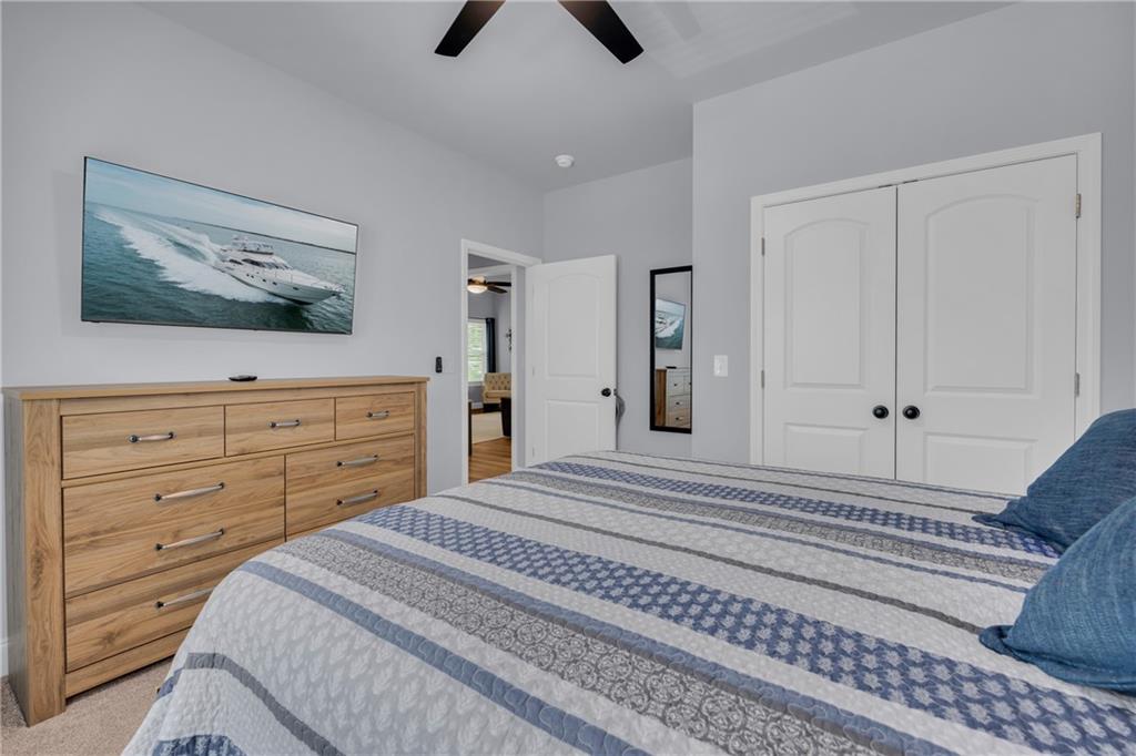 397 Normandy Trail Lavonia, GA 30553 - Photo 27 of 47 a bedroom with a bed and a chandelier