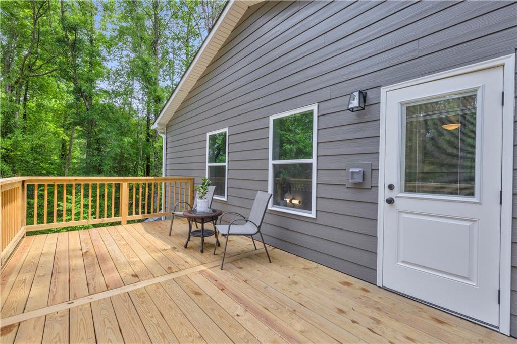 397 Normandy Trail Lavonia, GA 30553 - Photo 30 of 47 a balcony with wooden floor table and chairs