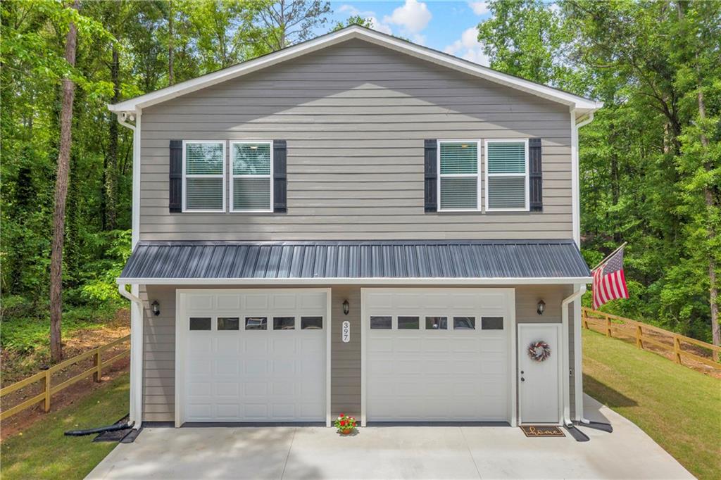 397 Normandy Trail Lavonia, GA 30553 - Photo 3 of 47 a front view of a house with a garage