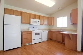 a kitchen with a white stove top oven sink and window