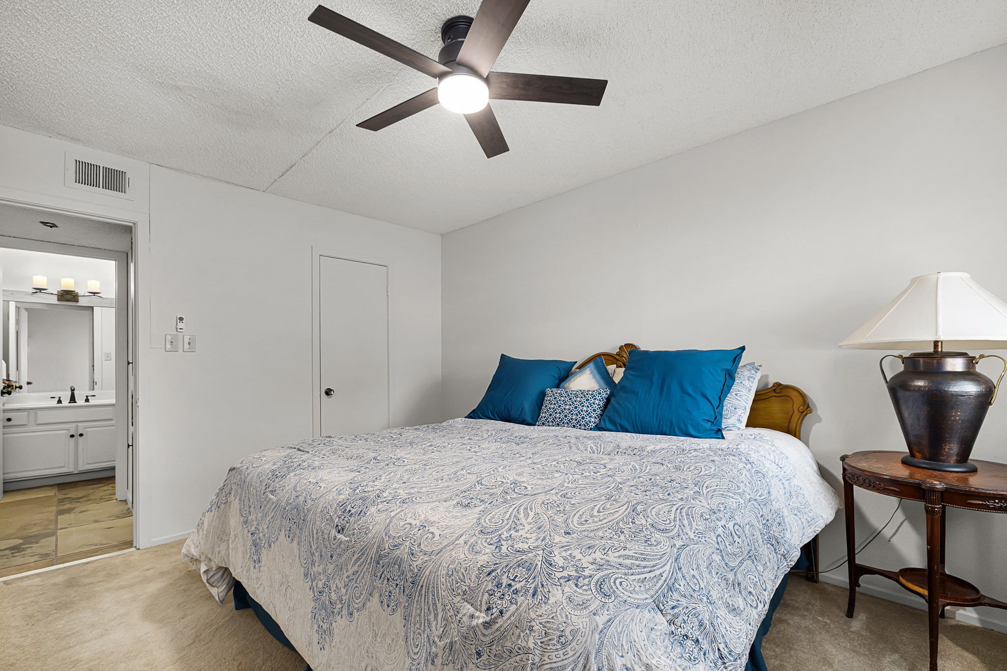 229 Comanche Lane Point Venture, TX 78645 - Photo 32 of 38 a bedroom with a bed and a chandelier