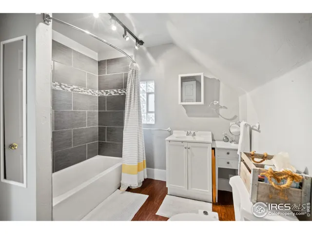 a bathroom with a tub sink and a mirror