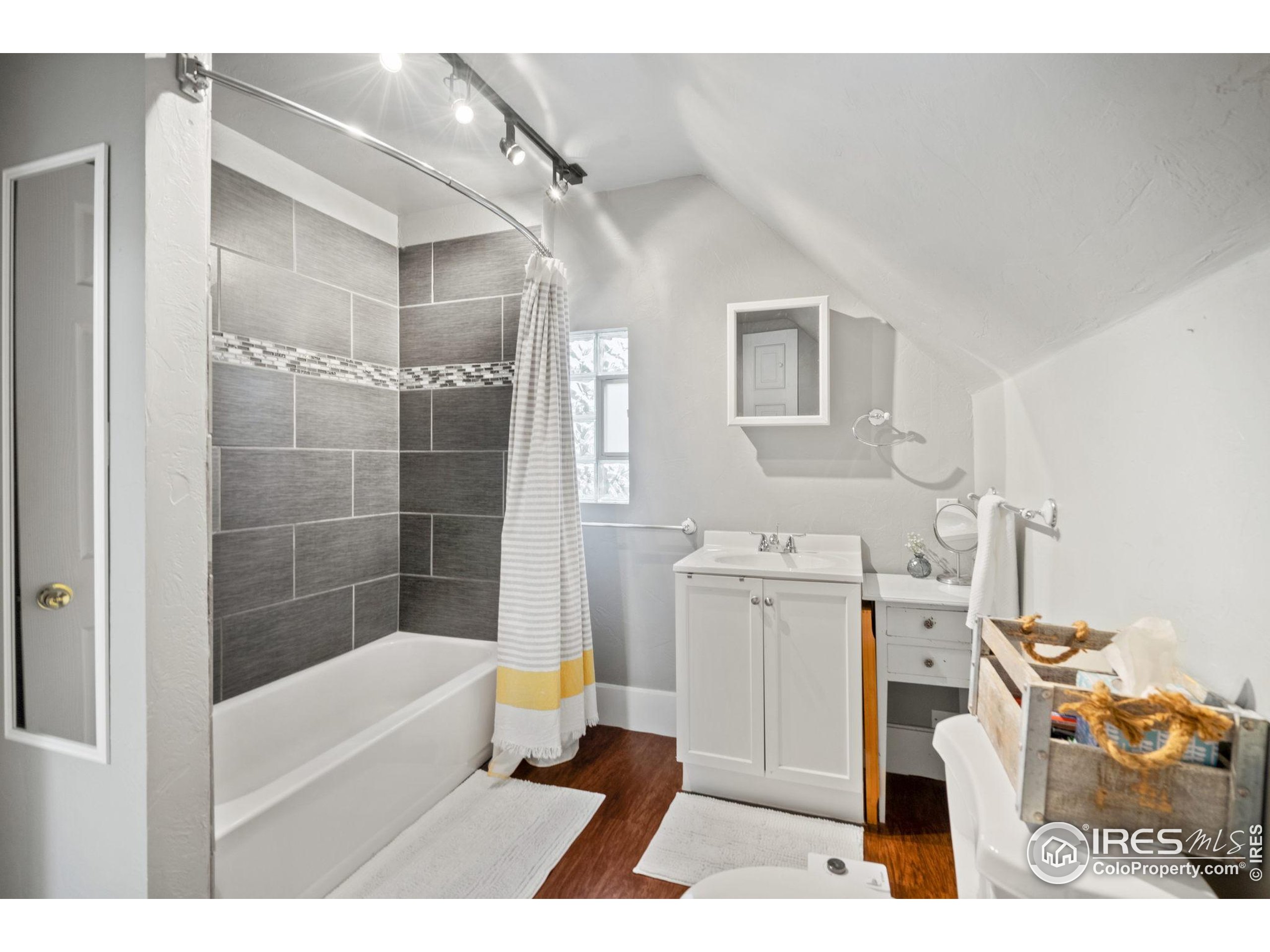 322 Maple Avenue Eaton, CO 80615 - Photo 13 of 26 a bathroom with a tub sink and a mirror
