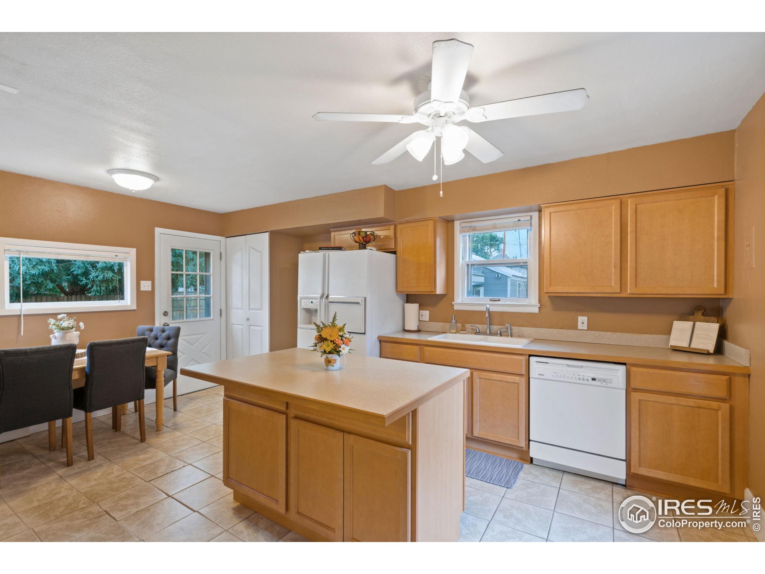 322 Maple Avenue Eaton, CO 80615 - Photo 6 of 26 a kitchen with a sink appliances and a large window