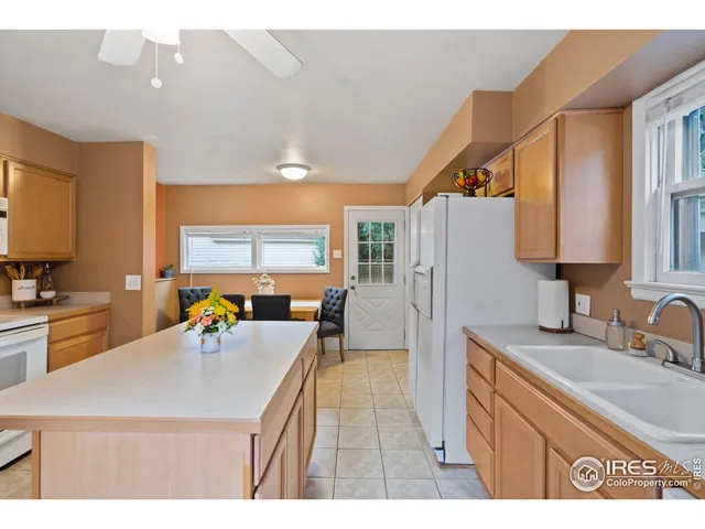 a kitchen with a sink a counter top space cabinets and stainless steel appliances
