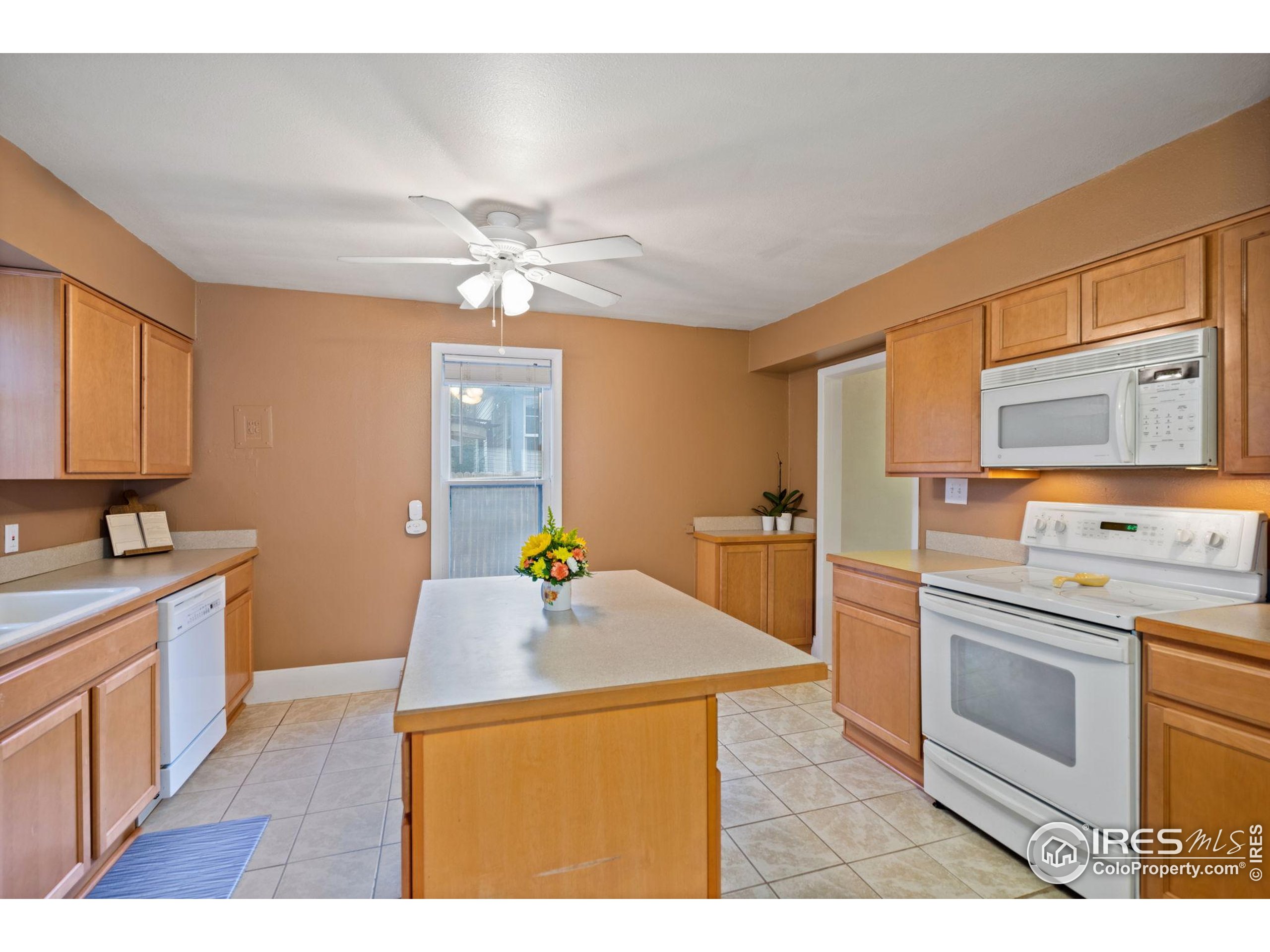 322 Maple Avenue Eaton, CO 80615 - Photo 8 of 26 a kitchen with a sink a stove and cabinets