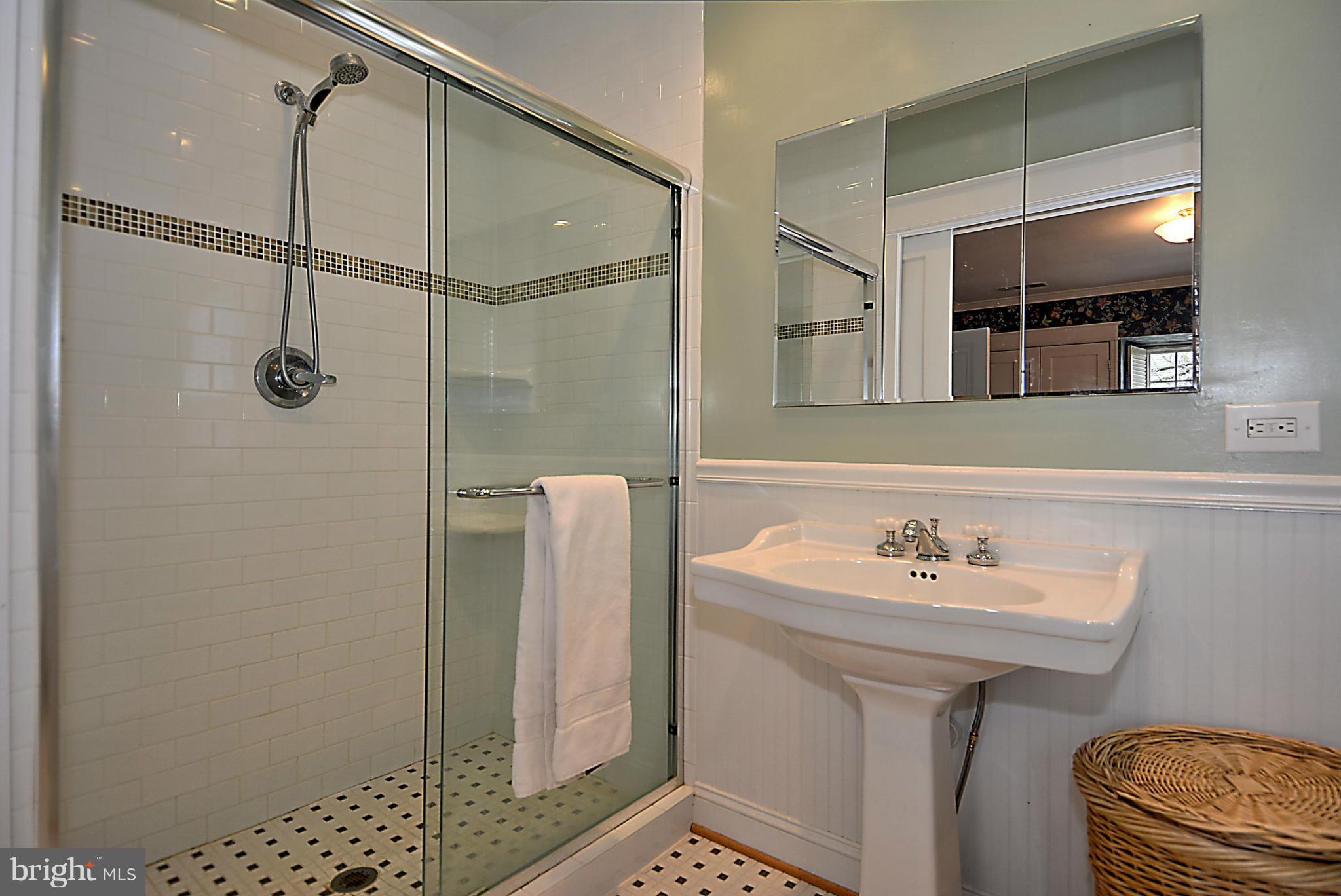 1909 Stratton Road Silver Spring, MD 20910 - Photo 13 of 22 a bathroom with a sink a mirror and shower