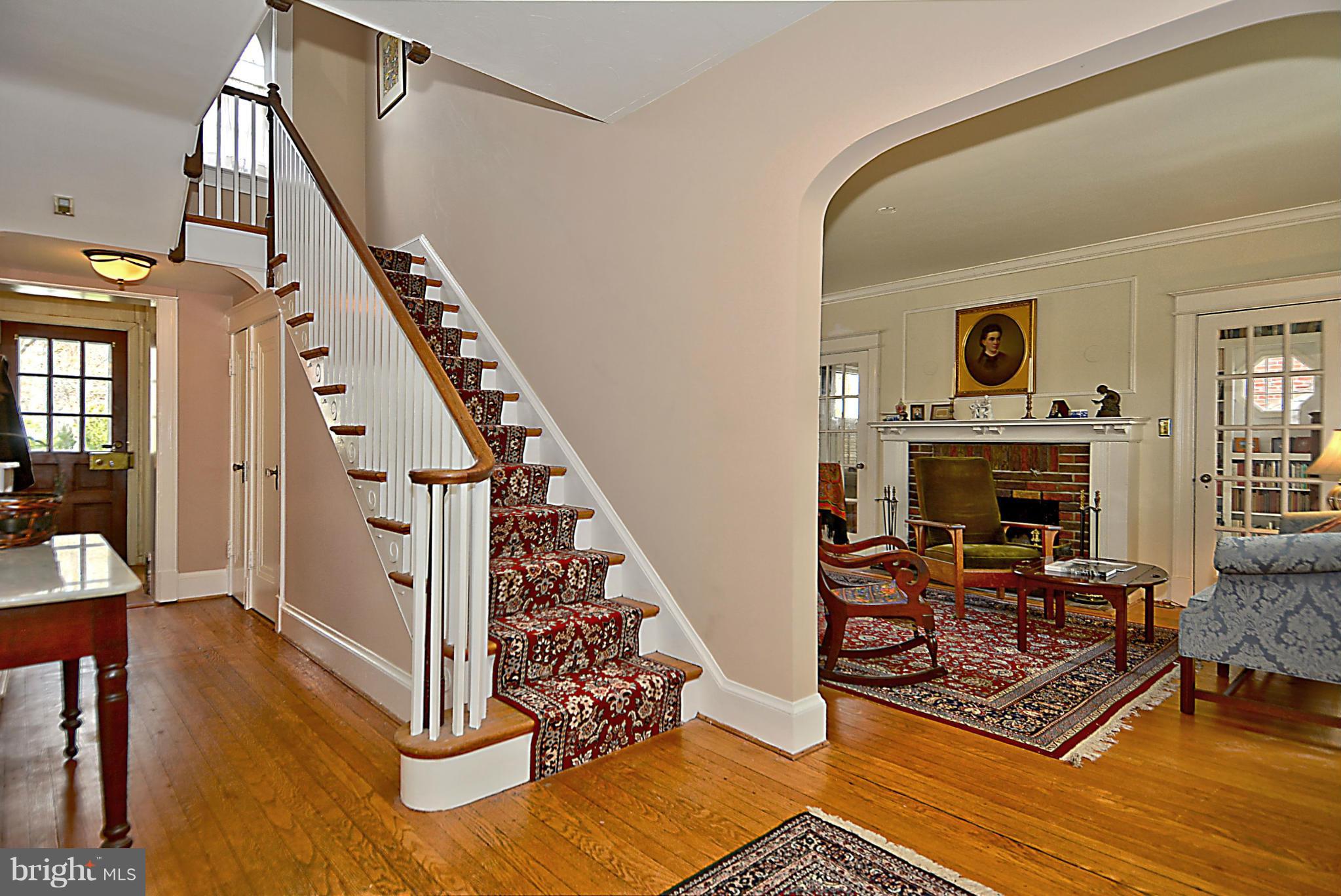 1909 Stratton Road Silver Spring, MD 20910 - Photo 4 of 22 a living room with wooden floor furniture and a fireplace